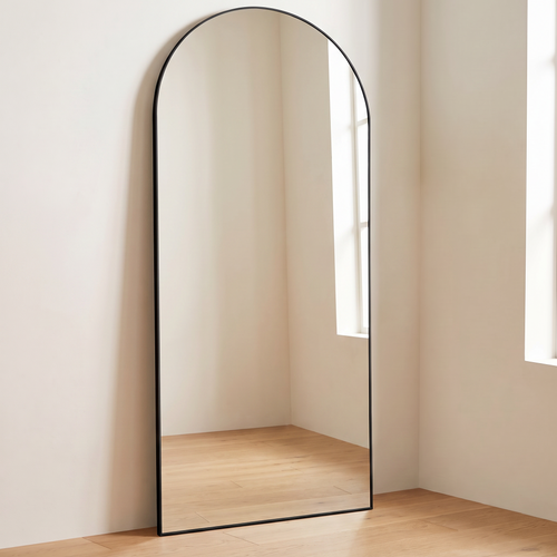 Aurella mirror standing in a bright bedroom corner