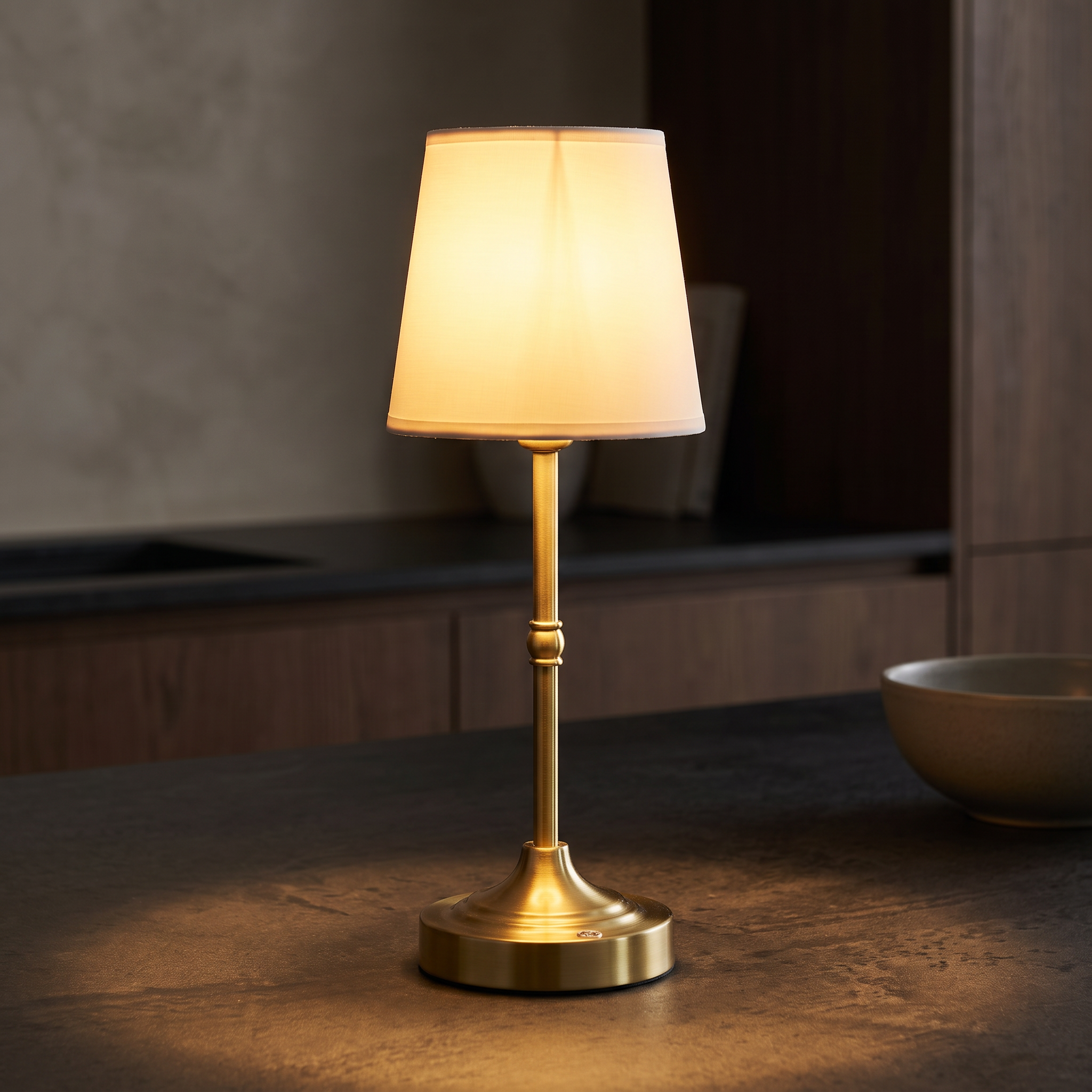 Lumina lamp casting a warm pool of light on a counter